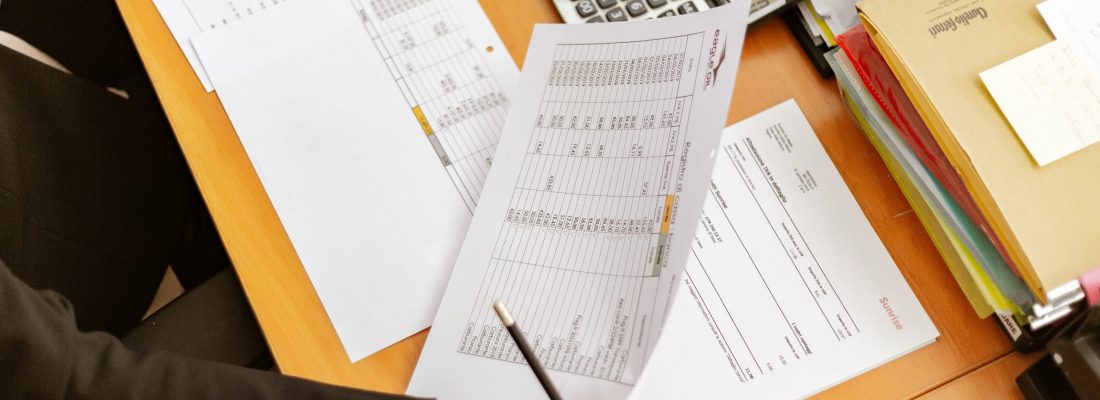 person-holding-white-printer-paper-and-pen-2058136